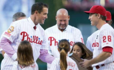 Jul 31, 2015; Philadelphia, PA, USA; Philadelphia Phillies second baseman Chase Utley (26) hands a plaque to retired left fielder Pat Burrell as is honored as the 37th inductee into the Phillies Wall of Fame before a game against the Atlanta Braves at Citizens Bank Park. Mandatory Credit: Bill Streicher-USA TODAY Sports