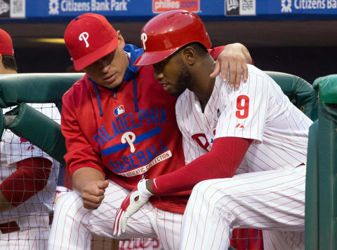 Aug 24, 2015; Philadelphia, PA, USA; Philadelphia Phillies catcher Carlos Ruiz (51) talks with Philadelphia Phillies right fielder Domonic Brown (9) on the dugout step during the second inning against the New York Mets at Citizens Bank Park. The Mets won 16-7. Mandatory Credit: Bill Streicher-USA TODAY Sports