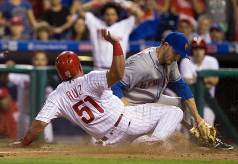 Jul 16, 2016; Philadelphia, PA, USA; Philadelphia Phillies catcher Carlos Ruiz (51) scores past New York Mets relief pitcher Erik Goeddel (62) on a wild pitch during the eighth inning at Citizens Bank Park. The Philadelphia Phillies won 4-2. Mandatory Credit: Bill Streicher-USA TODAY Sports