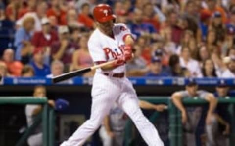 Aug 18, 2016; Philadelphia, PA, USA; Philadelphia Phillies second baseman Taylor Featherston (21) hits an RBI double during the fourth inning against the Los Angeles Dodgers at Citizens Bank Park. Mandatory Credit: Bill Streicher-USA TODAY Sports