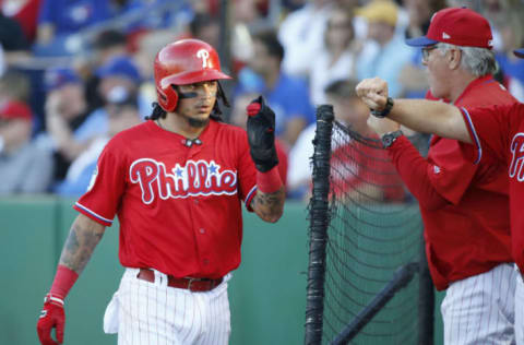 Mar 28, 2017; Clearwater, FL, USA; Philadelphia Phillies shortstop Freddy Galvis (13) is congratulated by manager Pete Mackanin (45) after he scored a run during the first inning against the Toronto Blue Jays at Spectrum Field. Mandatory Credit: Kim Klement-USA TODAY Sports