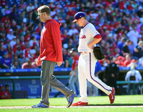 Apr 9, 2017; Philadelphia, PA, USA; Philadelphia Phillies starting pitcher Jeremy Hellickson (58) walks off the field with assistant trainer Shawn Fcasni after injuring his right hand in the top of the sixth inning against the Washington Nationals at Citizens Bank Park. Mandatory Credit: Eric Hartline-USA TODAY Sports