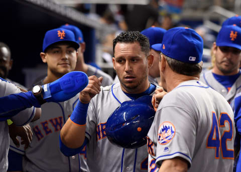 Apr 15, 2017; Miami, FL, USA; New York Mets shortstop Asdrubal Cabrera (center) celebrates after scoring a run during the first inning against the Miami Marlins at Marlins Park. Mandatory Credit: Steve Mitchell-USA TODAY Sports