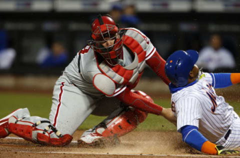 Apr 19, 2017; New York City, NY, USA; Philadelphia Phillies catcher Cameron Rupp (29) tags New York Mets left fielder Yoenis Cespedes (52) for an out in the first inning at Citi Field. Mandatory Credit: Noah K. Murray-USA TODAY Sports