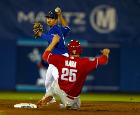 Mar 27, 2017; Dunedin, FL, USA; Toronto Blue Jays second baseman Darwin Barney (18) gets the force out on Philadelphia Phillies right fielder Daniel Nava (25) but does not complete the double play in the sixth inning of a baseball game during spring training at Florida Auto Exchange Stadium. Mandatory Credit: Butch Dill-USA TODAY Sports