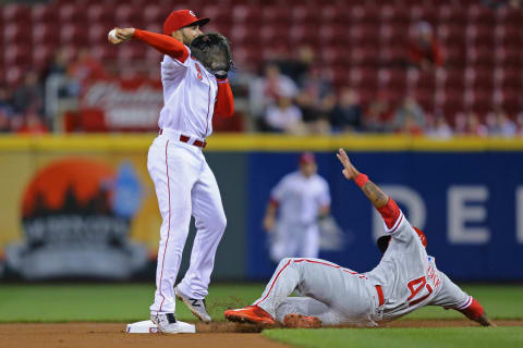 Apr 5, 2017; Cincinnati, OH, USA; Cincinnati Reds shortstop Jose Peraza (9) tags the base to force out Philadelphia Phillies left fielder Howie Kendrick (47) in the first inning at Great American Ball Park. Mandatory Credit: Aaron Doster-USA TODAY Sports