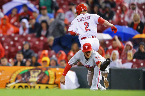 Apr 5, 2017; Cincinnati, OH, USA; Cincinnati Reds shortstop Zack Cozart (2) beats the throw to Philadelphia Phillies first baseman Tommy Joseph (19) for a base hit in the fifth inning at Great American Ball Park. Mandatory Credit: Aaron Doster-USA TODAY Sports