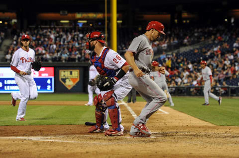 May 26, 2017; Philadelphia, PA, USA; Cincinnati Reds left fielder Adam Duvall (23) scores on a single by Cincinnati Reds second baseman Jose Peraza (9) during the sixth inning of the game against the Philadelphia Phillies at Citizens Bank Park. The Reds won the game 5-2. Mandatory Credit: John Geliebter-USA TODAY Sports