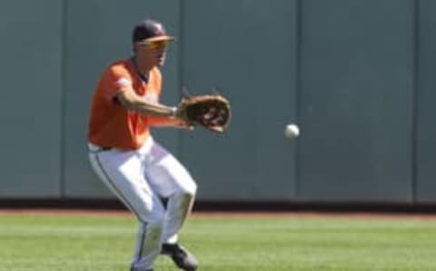 Jun 19, 2015; Omaha, NE, USA; Virginia Cavaliers center fielder Adam Haseley (7) fields the ball against the Florida Gators in the sixth inning in the 2015 College World Series at TD Ameritrade Park. Florida won 10-5. Mandatory Credit: Bruce Thorson-USA TODAY Sports