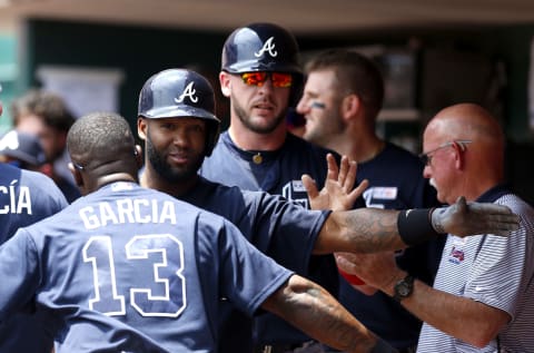 Jun 4, 2017; Cincinnati, OH, USA; Atlanta Braves left fielder Danny Santana (23) celebrates in the dugout with third baseman Adonis Garcia (13) after hitting a two-run home run against the Cincinnati Reds during the second inning at Great American Ball Park. Mandatory Credit: David Kohl-USA TODAY Sports