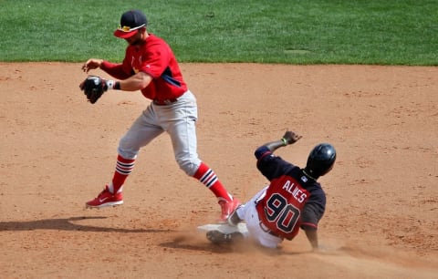 Mar 11, 2015; Lake Buena Vista, FL, USA; St. Louis Cardinals second baseman Greg Garcia (35) steps on second for the force out on Atlanta Braves Ozhaino Albies (90) during a spring training baseball game at Champion Stadium. The St. Louis Cardinals beat the Atlanta Braves 6-2. Mandatory Credit: Reinhold Matay-USA TODAY Sports