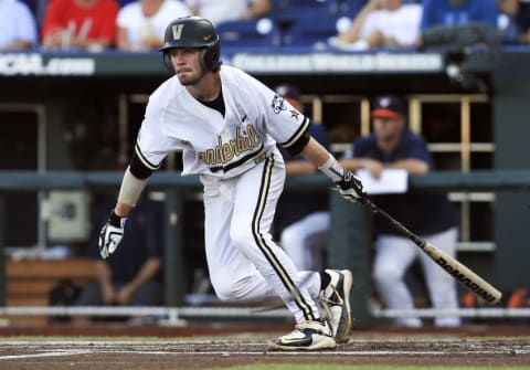 Jun 24, 2015; Omaha, NE, USA; Vanderbilt Commodores shortstop Dansby Swanson (7) hits an rbi ground out during the first inning against the Virginia Cavaliers in game three of the College World Series Finals at TD Ameritrade Park. Mandatory Credit: Bruce Thorson-USA TODAY Sports