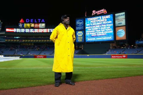 Oct 3, 2015; Atlanta, GA, USA; Security officer Jack Patterson stands guard at the edge of the field as the game between the Atlanta Braves and St. Louis Cardinals at Turner Field is postponed. Mandatory Credit: Kevin D. Liles-USA TODAY Sports