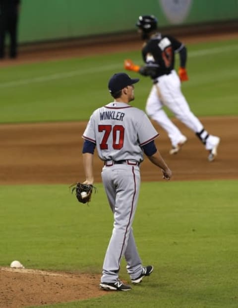 Sep 27, 2015; Miami, FL, USA; Atlanta Braves pitcher Daniel Winkler reacts as Miami Marlins center fielder Marcell Ozuna (13) rounds the bases after his home run in the seventh inning at Marlins Park. The Marlins won 9-5. Mandatory Credit: Robert Mayer-USA TODAY Sports