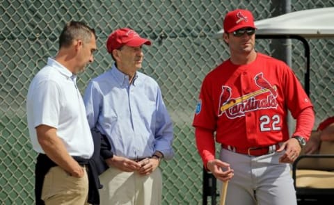 Feb 18, 2016; Jupiter, FL, USA; St. Louis Cardinals manager Mike Matheny (right) listens as general manager John Mozeliak (left) talks with chairman and chief executive officer William O. DeWitt, Jr. (center) at Roger Dean Stadium. Mandatory Credit: Steve Mitchell-USA TODAY Sports