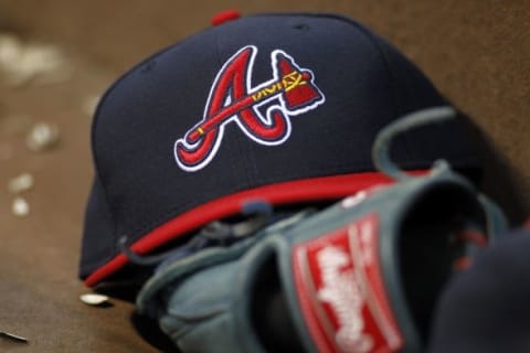 Apr 26, 2014; Atlanta, GA, USA; Detailed view of Atlanta Braves hat and glove in the dugout against the Cincinnati Reds in the third inning at Turner Field. Mandatory Credit: Brett Davis-USA TODAY Sports