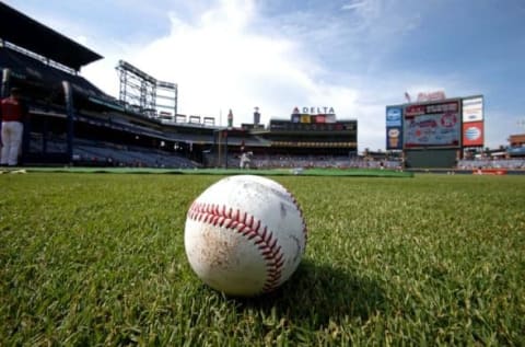 Jul 21, 2015; Atlanta, GA, USA; A baseball, baseball glove and baseballs are shown on the infield during batting practice before the game against the Atlanta Braves and the Los Angeles Dodgers at Turner Field. Mandatory Credit: Jason Getz-USA TODAY Sports