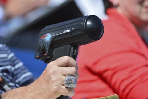 Mar 1, 2014; Melbourne, FL, USA; A scout measures pitch speeds with a radar gun during spring training game between the Atlanta Braves and the Washington Nationals at Space Coast Stadium. Mandatory Credit: Tommy Gilligan-USA TODAY Sports