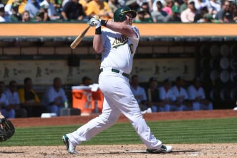 September 3, 2014; Oakland, CA, USA; Oakland Athletics designated hitter Adam Dunn (10) hits a solo home run during the fourth inning against the Seattle Mariners at O.co Coliseum. The Mariners defeated the Athletics 2-1. Mandatory Credit: Kyle Terada-USA TODAY Sports