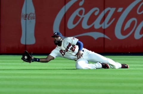 Aug 9, 2014; Atlanta, GA, USA; Atlanta Braves right fielder Jason Heyward (22) makes a diving catch on a ball hit by Washington Nationals third baseman Anthony Rendon (not pictured) during the first inning at Turner Field. Mandatory Credit: Dale Zanine-USA TODAY Sports