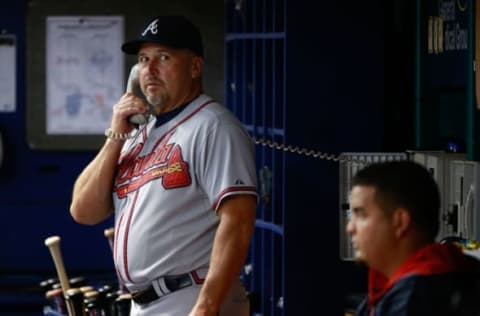 Aug 11, 2015; St. Petersburg, FL, USA; Atlanta Braves manager Fredi Gonzalez (33) looks on while calling the bullpen in the dugout at Tropicana Field. Mandatory Credit: Kim Klement-USA TODAY Sports