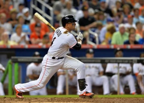 Apr 6, 2015; Miami, FL, USA; Miami Marlins second baseman Martin Prado (14) connects for a base hit during the seventh inning against the Atlanta Braves at Marlins Park. The Braves won 2-1. Mandatory Credit: Steve Mitchell-USA TODAY Sports