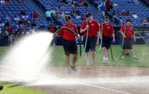 Jun 19, 2015; Atlanta, GA, USA; Members of the Atlanta Braves grounds crew waters the infield before the Braves games against the New York Mets at Turner Field. Mandatory Credit: Jason Getz-USA TODAY Sports