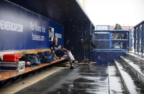 Mar 19, 2016; Tampa, FL, USA; Atlanta Braves pitching coach Roger McDowell (45) sits in the dugout in the rain before the game between the New York Yankees and the Braves at George M. Steinbrenner Field. Mandatory Credit: Jerome Miron-USA TODAY Sports