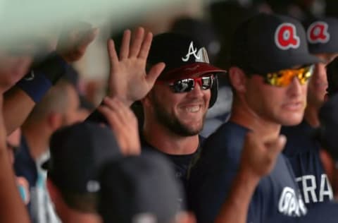 Mar 18, 2016; Lake Buena Vista, FL, USA; Atlanta Braves catcher Tyler Flowers (25) is congratulated in the dugout as he scores during the fourth inning against the Miami Marlins at Champion Stadium. Mandatory Credit: Kim Klement-USA TODAY Sports