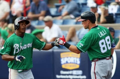 Mar 17, 2016; Melbourne, FL, USA; Atlanta Braves center fielder Mallex Smith (63) celebrates with Atlanta Braves catcher Blake Lalli (88) after scoring a run in the seventh inning against the Washington Nationals at Space Coast Stadium. The Washington Nationals won 9-7. Mandatory Credit: Logan Bowles-USA TODAY Sports