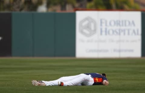 Mar 5, 2016; Kissimmee, FL, USA; Houston Astros first baseman A.J. Reed (80) lays in the outfield before a spring training baseball game against the New York Mets at Osceola County Stadium. Mandatory Credit: Reinhold Matay-USA TODAY Sports