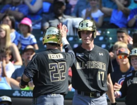 Aug 15, 2015; Chicago, IL, USA; American team Carter Kieboom (22) is greeted by Joey Wentz (17) after scoring a run against the National team during the first inning in the Under Armour All America Baseball game at Wrigley field. Mandatory Credit: David Banks-USA TODAY Sports