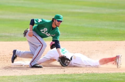 Mar 17, 2016; Melbourne, FL, USA; Washington Nationals left fielder Matt den Dekker (21) slides as Atlanta Braves shortstop Dansby Swanson (80) fields a ball in the ninth inning at Space Coast Stadium. The Washington Nationals won 9-7. Mandatory Credit: Logan Bowles-USA TODAY Sports