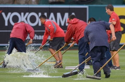 Jul 19, 2015; Anaheim, CA, USA; A general view as workers try and brush the water off the outfield as the game between the Los Angeles Angels and the Boston Red Sox at Angel Stadium of Anaheim was officially called a rain out. This is the first time the Angels have been rained out at home since June 16, 1995. Mandatory Credit: Jayne Kamin-Oncea-USA TODAY Sports