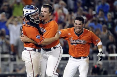 Jun 24, 2015; Omaha, NE, USA; Virginia Cavaliers pitcher Nathan Kirby (middle) hugs catcher Matt Thaiss (left) after the game against the Vanderbilt Commodores in game three of the College World Series Final at TD Ameritrade Park. Virginia defeated Vanderbilt 4-2 to win the College World Series. Mandatory Credit: Steven Branscombe-USA TODAY Sports