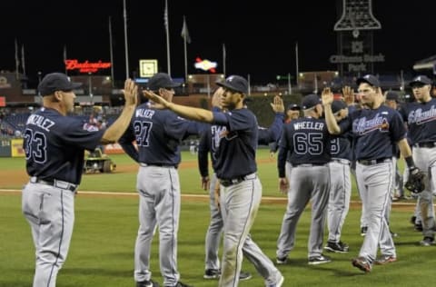 Sep 27, 2014; Philadelphia, PA, USA; Atlanta Braves manager Fredi Gonzalez (33) high fives Atlanta Braves shortstop Andrelton Simmons (19) after he caught the final out against the Philadelphia Phillies at Citizens Bank Park. The Braves defeated the Phillies, 4-2. Mandatory Credit: Eric Hartline-USA TODAY Sports