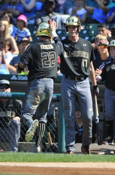 Aug 15, 2015; Chicago, IL, USA; American team Carter Kieboom (22) is greeted by Joeey Wentz (17) after scoring a run against the National team during the first inning in the Under Armour All America Baseball game at Wrigley field. Mandatory Credit: David Banks-USA TODAY Sports