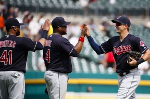 Jun 26, 2016; Detroit, MI, USA; Cleveland Indians first baseman Carlos Santana (41) third baseman Juan Uribe (4) and right fielder Lonnie Chisenhall (8) celebrate after the game against the Detroit Tigers at Comerica Park. Cleveland won 9-3. Mandatory Credit: Rick Osentoski-USA TODAY Sports