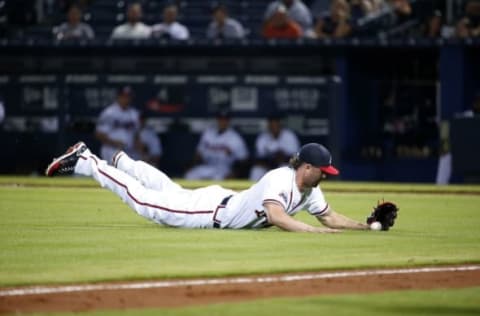 May 25, 2016; Atlanta, GA, USA; Atlanta Braves relief pitcher Casey Kelly (55) is unable to make the out on a bunt by Milwaukee Brewers center fielder Keon Broxton (not pictured) in the 13th inning of their game at Turner Field. The Brewers won 3-2 in 13 innings. Mandatory Credit: Jason Getz-USA TODAY Sports