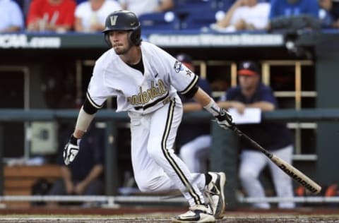 Jun 24, 2015; Omaha, NE, USA; Vanderbilt Commodores shortstop Dansby Swanson (7) hits an rbi ground out during the first inning against the Virginia Cavaliers in game three of the College World Series Finals at TD Ameritrade Park. Mandatory Credit: Bruce Thorson-USA TODAY Sports