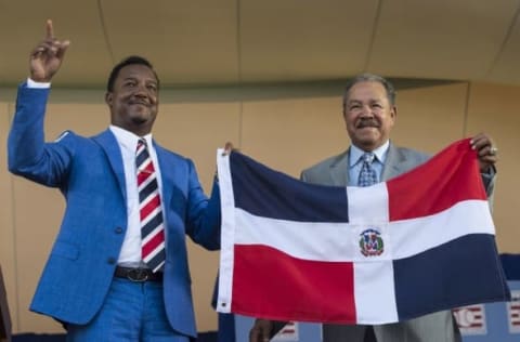 Jul 26, 2015; Cooperstown, NY, USA; Hall of Fame Inductee Pedro Martinez (L) and Hall of Famer Juan Marichal (R) hold up the Dominican Republic flat at the end of his acceptance speech during the Hall of Fame Induction Ceremonies at Clark Sports Center. Mandatory Credit: Gregory J. Fisher-USA TODAY Sports