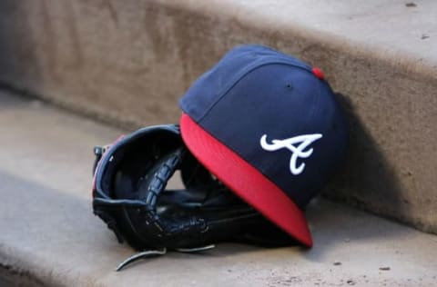 Aug 25, 2015; Atlanta, GA, USA; Detailed view of Atlanta Braves hat and glove in the dugout before a game against the Colorado Rockies at Turner Field. Mandatory Credit: Brett Davis-USA TODAY Sports