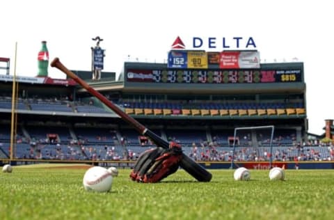 Jul 21, 2015; Atlanta, GA, USA; A baseball, baseball glove and baseballs are shown on the infield during batting practice before the game against the Atlanta Braves and the Los Angeles Dodgers at Turner Field. Mandatory Credit: Jason Getz-USA TODAY Sports