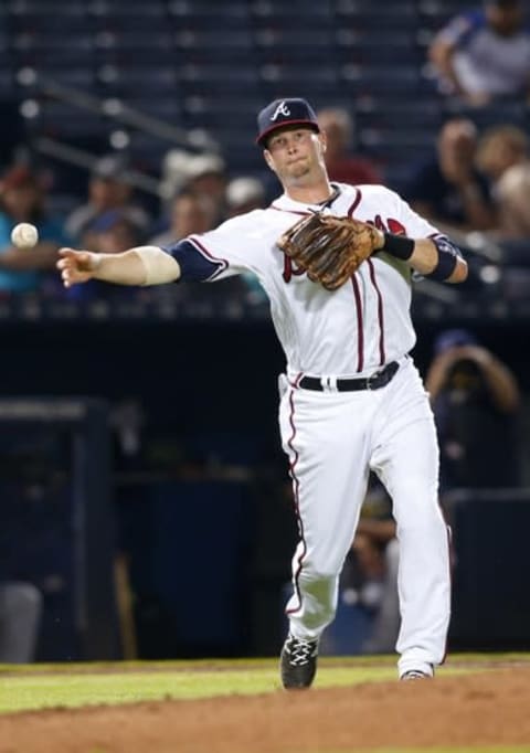 May 26, 2016; Atlanta, GA, USA; Atlanta Braves third baseman Reid Brignac (4) throws a runner out at first against the Milwaukee Brewers in the ninth inning at Turner Field. The Brewers defeated the Braves 6-2. Mandatory Credit: Brett Davis-USA TODAY Sports