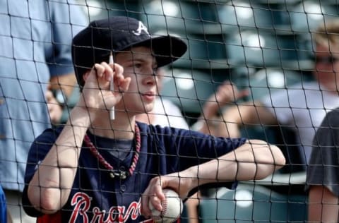 Mar 15, 2015; Lake Buena Vista, FL, USA; A young Atlanta Braves fan tries to get an autograph before a spring training baseball game against the Toronto Blue Jays at Champion Stadium. Mandatory Credit: Reinhold Matay-USA TODAY Sports