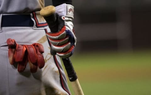 Sep 9, 2015; Philadelphia, PA, USA; The batting glove and bat of Atlanta Braves first baseman Nick Swisher (23) as he waits on deck against the Philadelphia Phillies at Citizens Bank Park. The Braves won 8-1. Mandatory Credit: Bill Streicher-USA TODAY Sports