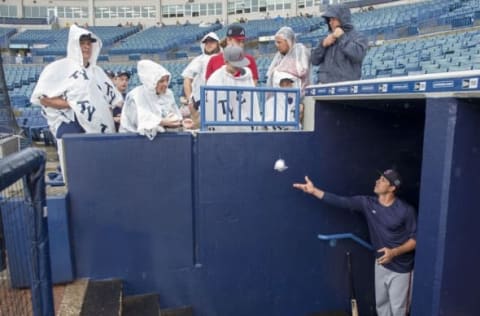 Mar 19, 2016; Tampa, FL, USA; Atlanta Braves infielder Sean Kazmar tosses a signed baseball to a fan before the game between the New York Yankees and the Braves at George M. Steinbrenner Field. Mandatory Credit: Jerome Miron-USA TODAY Sports