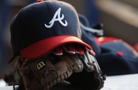 Jul 26, 2014; Atlanta, GA, USA; Detailed view of Atlanta Braves second baseman Tommy La Stella (not pictured) hat and glove in the dugout against the San Diego Padres in the third inning at Turner Field. Mandatory Credit: Brett Davis-USA TODAY Sports