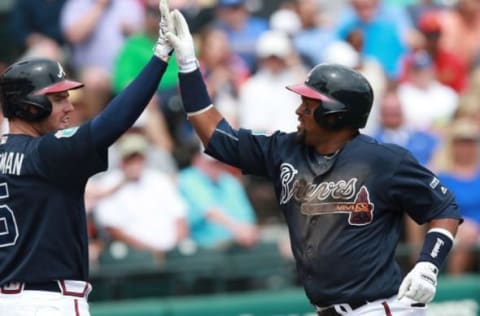 Mar 18, 2016; Lake Buena Vista, FL, USA; Atlanta Braves second baseman Emillio Bonifacio (64) is congratulated by first baseman Fredddie Freeman (5) as he hit a solo home run during the third inning against the Miami Marlins at Champion Stadium. Mandatory Credit: Kim Klement-USA TODAY Sports