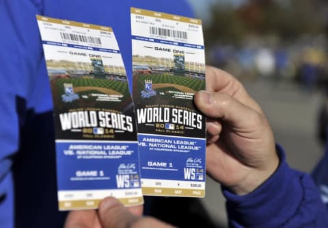 Oct 21, 2014; Kansas City, MO, USA; A fan holds up his baseball game tickets before game one of the 2014 World Series between the Kansas City Royals and the San Francisco Giants at Kauffman Stadium. Mandatory Credit: Christopher Hanewinckel-USA TODAY Sports